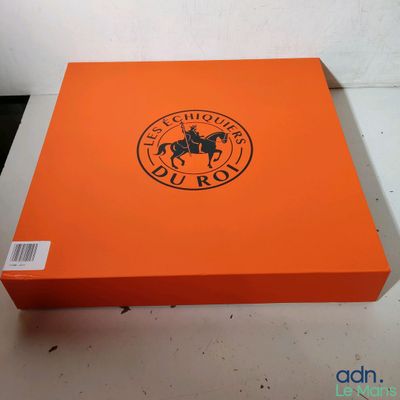 un gros plan d'une boîte orange sur laquelle figure un cheval