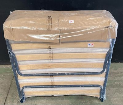 a stack of mattresses sitting on top of a pallet