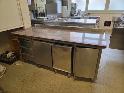 a large kitchen with stainless steel appliances in it