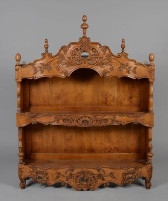 an old wooden shelf with ornate carvings on it