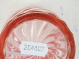 a glass jar with a label on it sitting on a table