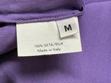 a close up of a label on the back of a purple shirt