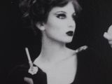 a black and white photo of a woman smoking a cigarette