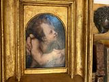 a picture of a woman holding a baby in a gold frame
