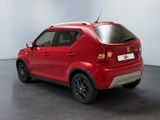 the rear end of a red car parked in a room