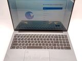 a laptop computer that is open on a white surface