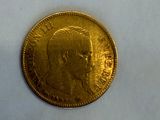 a close up of a gold coin on a white surface