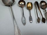 many spoons and spoon spoons lined up on a table