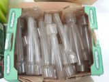 a box full of empty plastic cups sitting on a table
