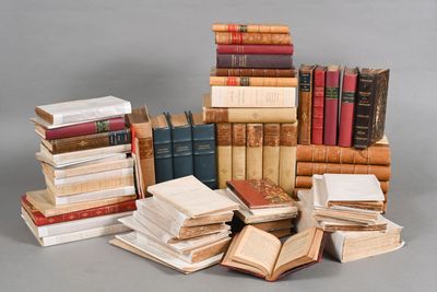 many books stacked on top of each other on a table