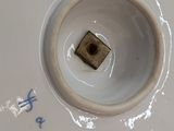 a white plate with a small square in the middle