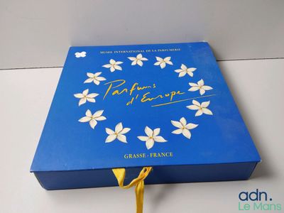 a close up of a blue box with white flowers on it