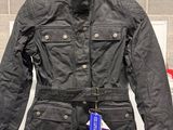 a black jacket hanging on a rack in a room