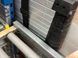 several pieces of metal are stacked on top of each other in a warehouse