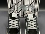 black and white sneakers with white laces and a box of black and white shoes