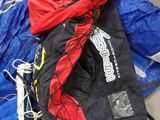 a blue and red jacket and a pair of skis on the ground