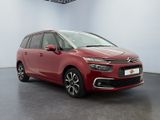 a red citrole is parked in a white room