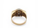 a close up of a gold and diamond ring on a white background
