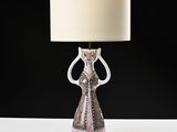 a lamp that is sitting on a table in front of a black background