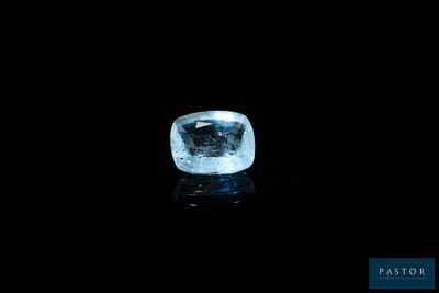 a blue diamond on a black surface in the dark