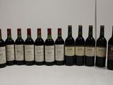 several bottles of wine are lined up on a table
