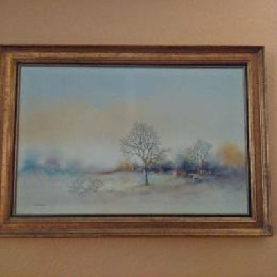 a picture of a painting on the wall above a bed