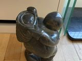 a statue of a man holding a baby in his arms