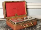 a small suitcase with a coin in it sitting on a table