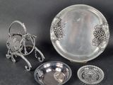 several pieces of silverware including a tray, bowl, and spoon
