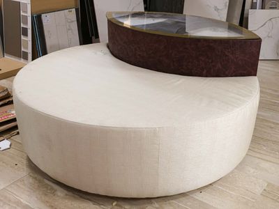 a large round ottoman sitting on a hard wood floor