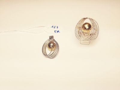 two pieces of jewelry on a table with a price tag