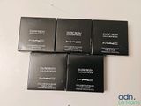 three boxes of mac cosmetics sitting on a table
