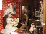 a doll that is sitting in a doll house