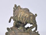 bronze statue of a man on a horse with a goat