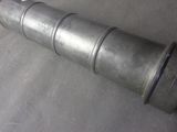 a metal pipe that is laying on the ground