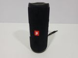 a close up of a black speaker on a white surface