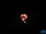 a pink diamond on a black background