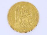 a gold coin on a white surface with a white background