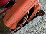 a red tractor and a red tractor in a garage