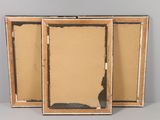 three framed pictures of a cat sitting on top of a table