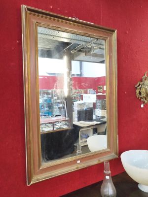 a mirror and a bowl on a table in a room