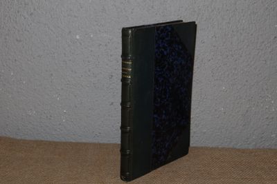 a black book sitting on a table with a blue cover