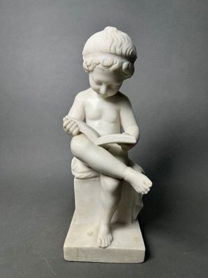 marble statue of a boy sitting on a stool with his legs crossed