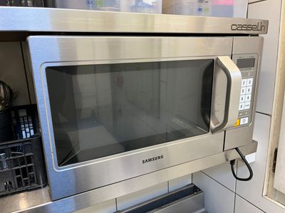 un micro-ondes argenté posé sur un plan de travail