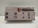 a box with a hair brush and a comb inside of it