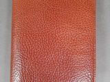 an orange leather passport case