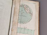 an open book with a drawing of a globe on it