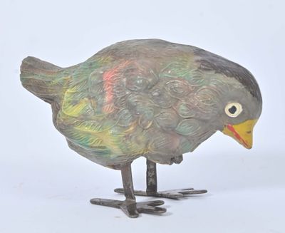 a small bird that is standing on a white surface