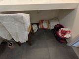 a bathroom with a sink, toilet, and a towel on the floor