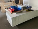 a desk that has a lot of boxes on it